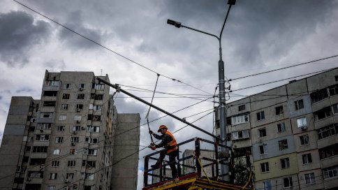 عامل يصلح خطوط الكهرباء في سالتيفكا في خاركيف بعدما استهدف القصف الروسي البنية التحتية للطاقة